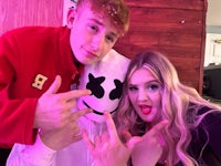 three people posing for a photo with a marshmello mask